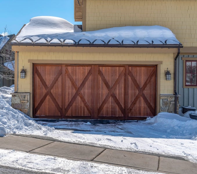 Exterior of home and garage in snowy neighborhood, Utah
