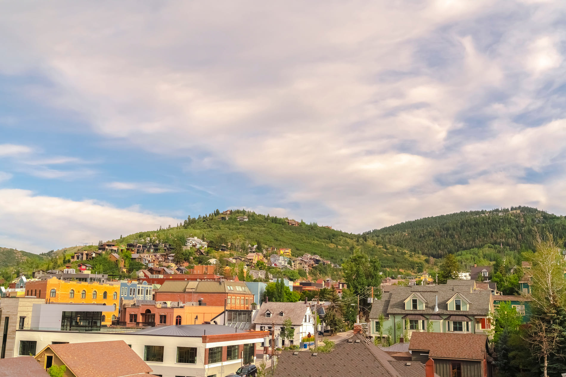 A batch of homes sitting on a hill in Park City, Utah during the summer months.