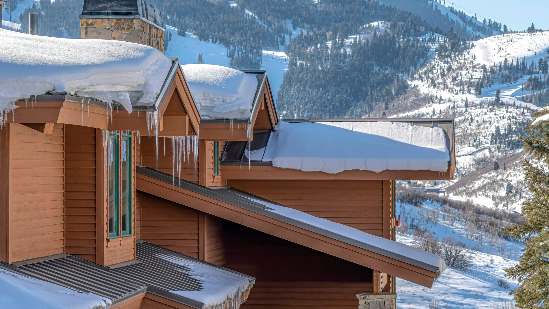 Sloped home roofs covered in snow outside of Park City, Utah